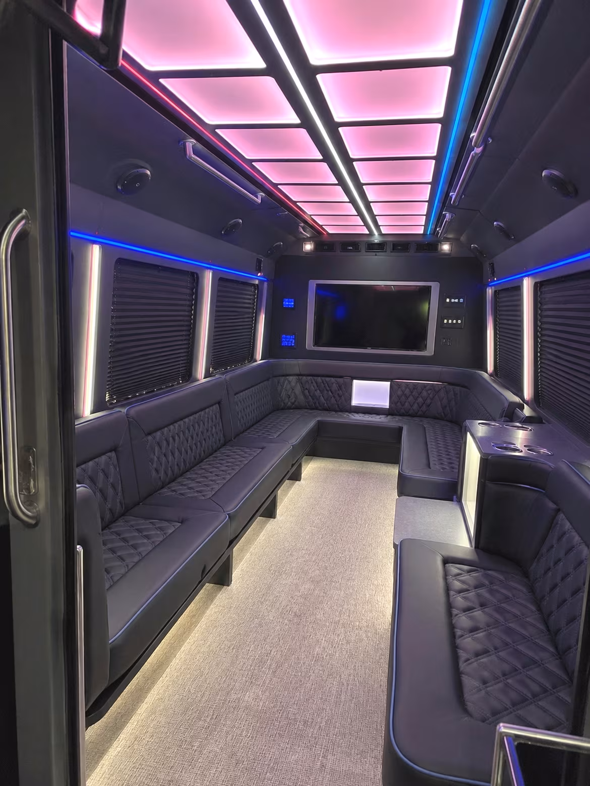 Friends laughing during a party bus celebration in Tyler